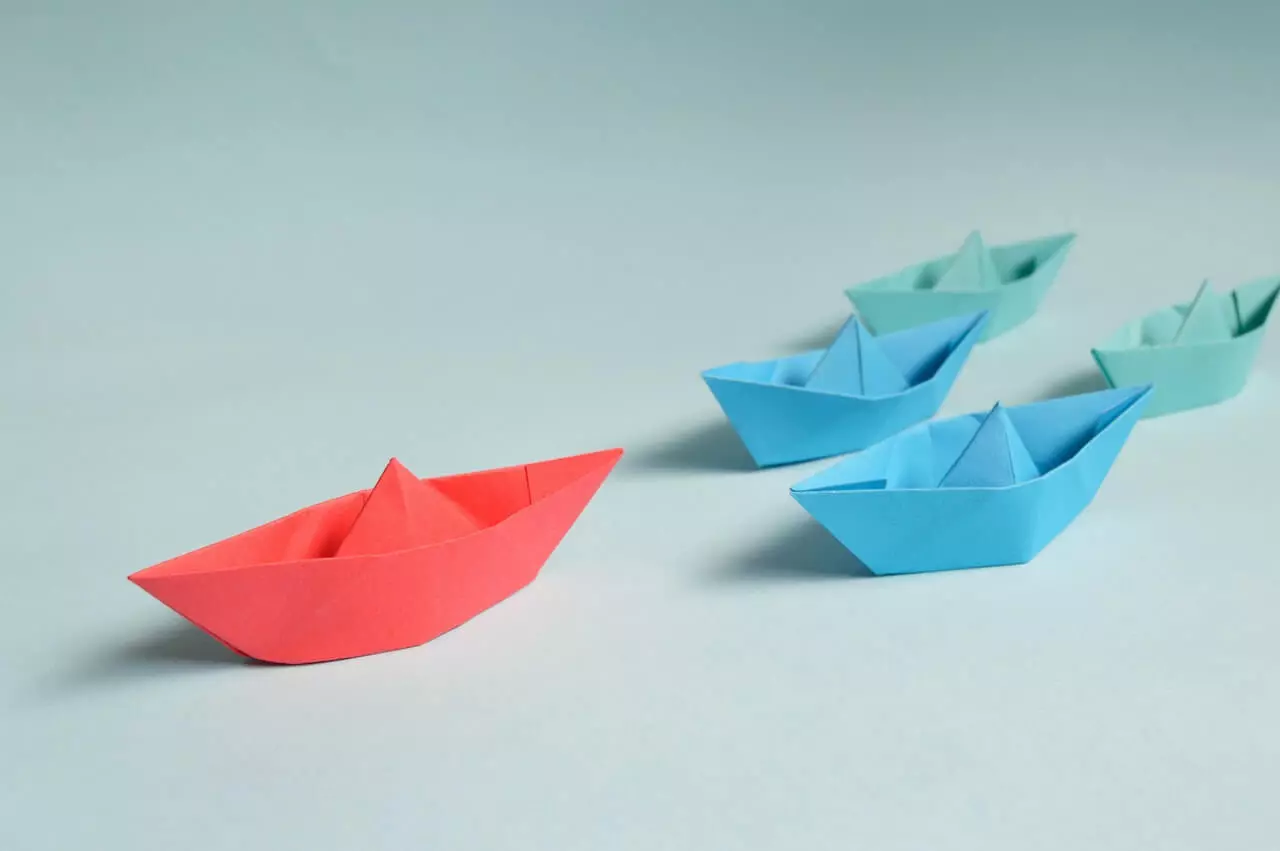 High Net Individuals Wealth Planning Paper Boats on Solid Surface